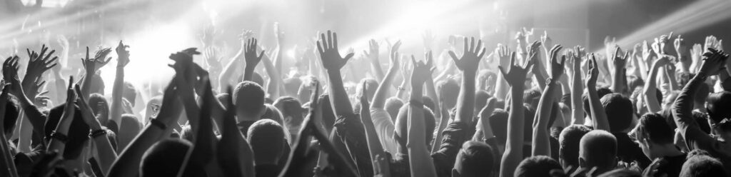 Background image of crowd with hands up at event/concert
